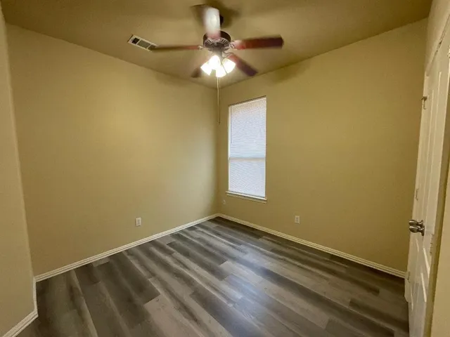 a view of room with window and ceiling fan