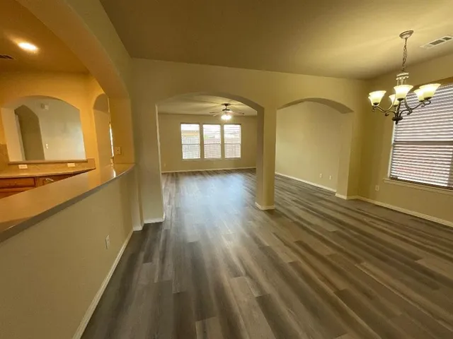 a view of a room with wooden floor and staircase