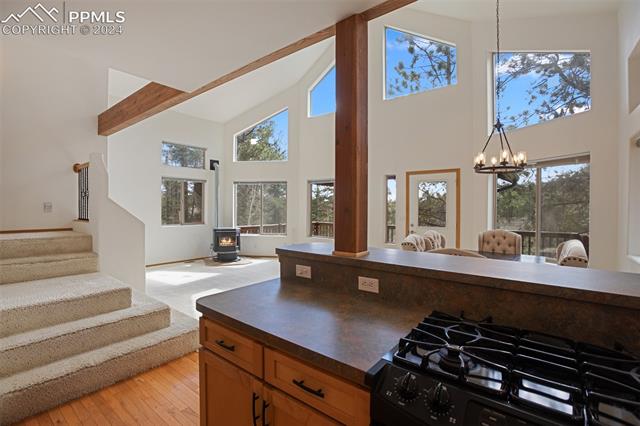 398 Pinewood Road Florissant, CO 80816 - Photo 13 of 43 Kitchen with high vaulted ceiling, gas stove, plenty of natural light, and an inviting chandelier