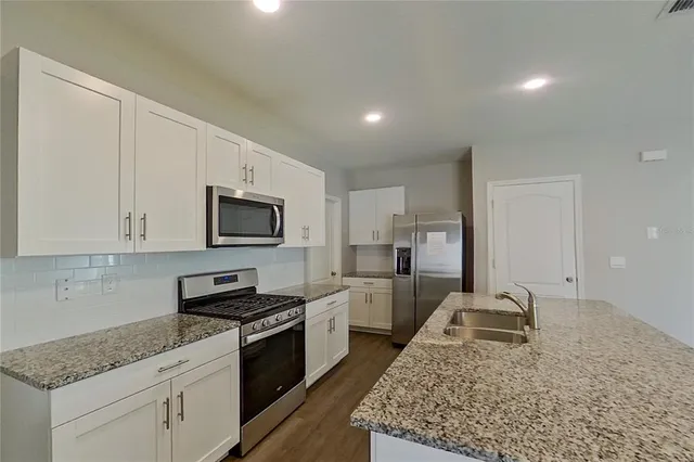 a kitchen with sink cabinets and stove