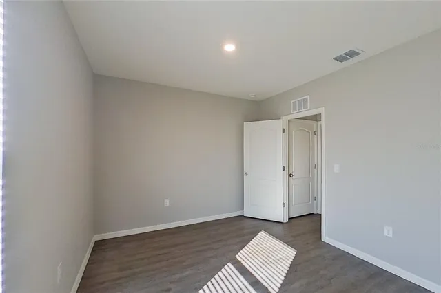 a view of an empty room and wooden floor