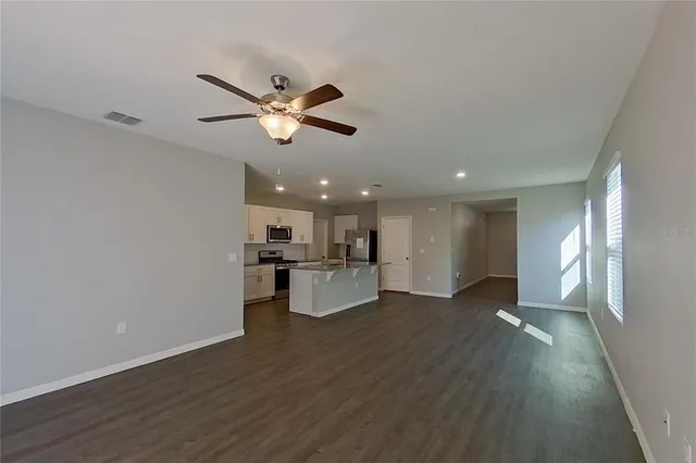 a view of a kitchen with a sink stainless steel appliances and cabinets