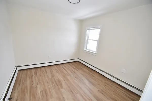 a view of an empty room and a window