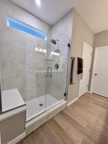 a bathroom with a shower and a mirror