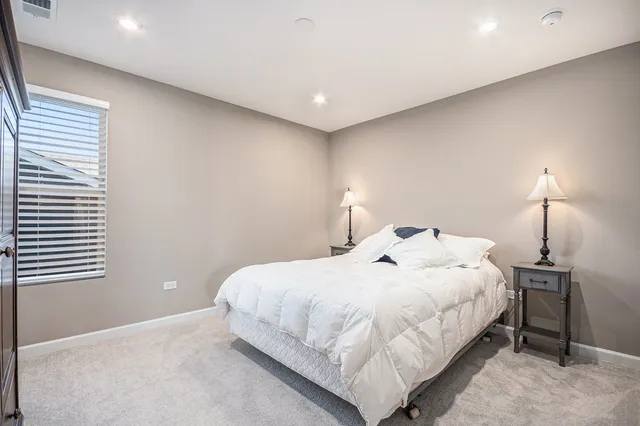 a bedroom with a bed and a lamp