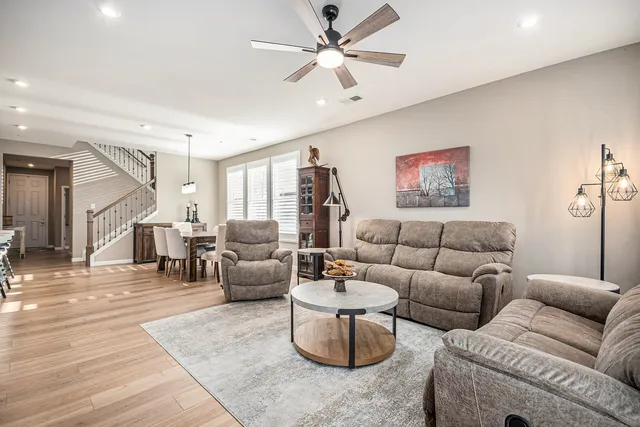 a living room with furniture and a chandelier