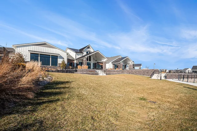 a living room with couches a dining table and chairs with wooden floor