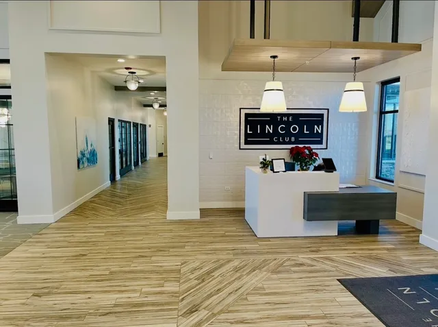 a living room with lots of furniture and a chandelier