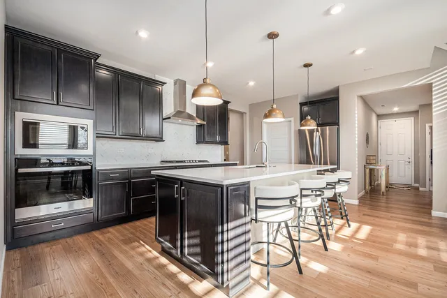 a kitchen with a sink stove and cabinets