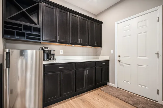 a kitchen with a refrigerator and cabinets