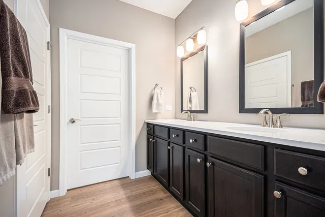 a bathroom with a double vanity sink and a mirror