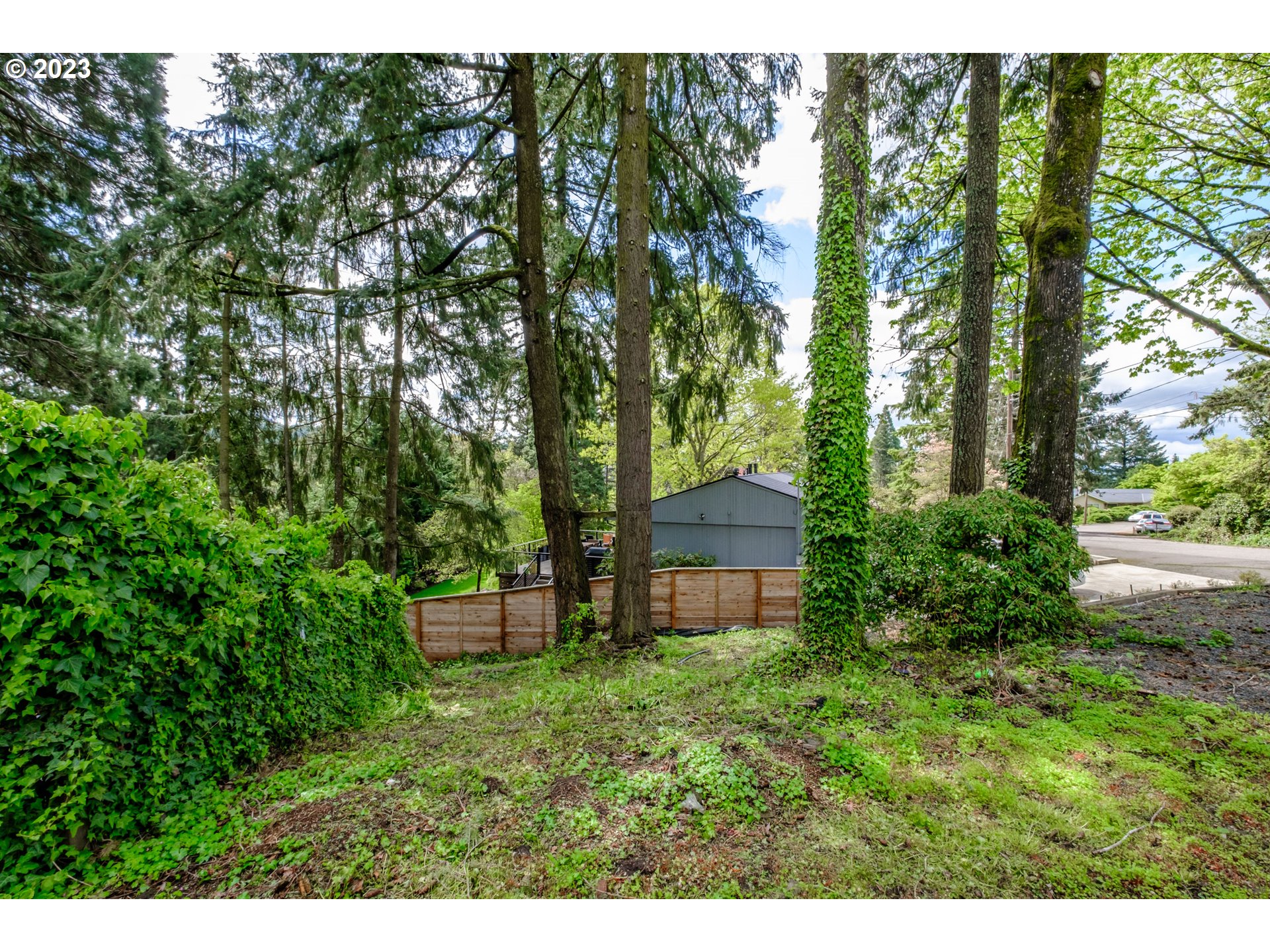 10200 Southwest 61st Avenue, Unit P2 Portland, OR 97219 - Photo 4 of 12 a backyard of a house with a garden and outdoor seating
