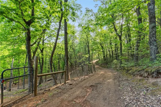 a view of house with a yard and sitting area