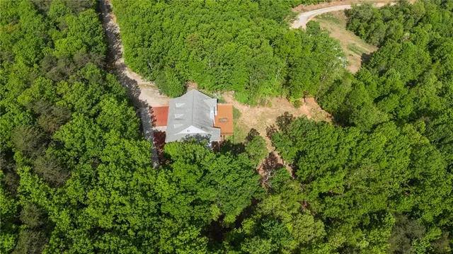 a view of a livingroom with furniture staircase and kitchen view
