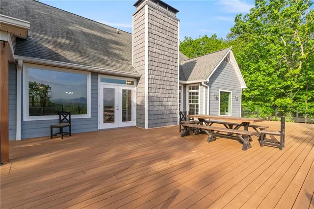 a bathroom with a double vanity sink a toilet a mirror and shower