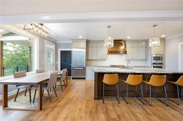 a view of a yard with plants and a large tree