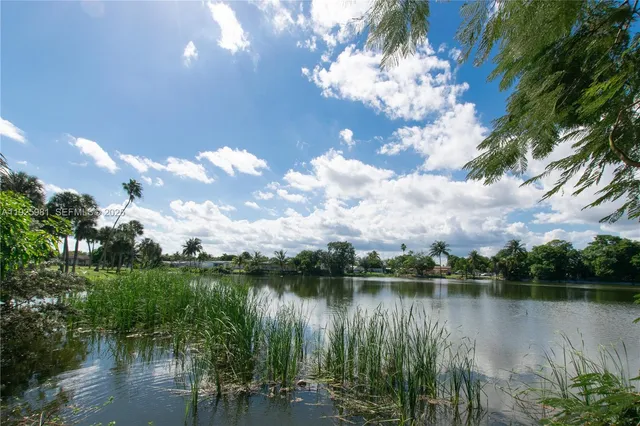 a view of a lake with a yard and mountain view