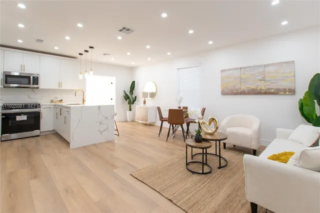 a living room with furniture and kitchen view