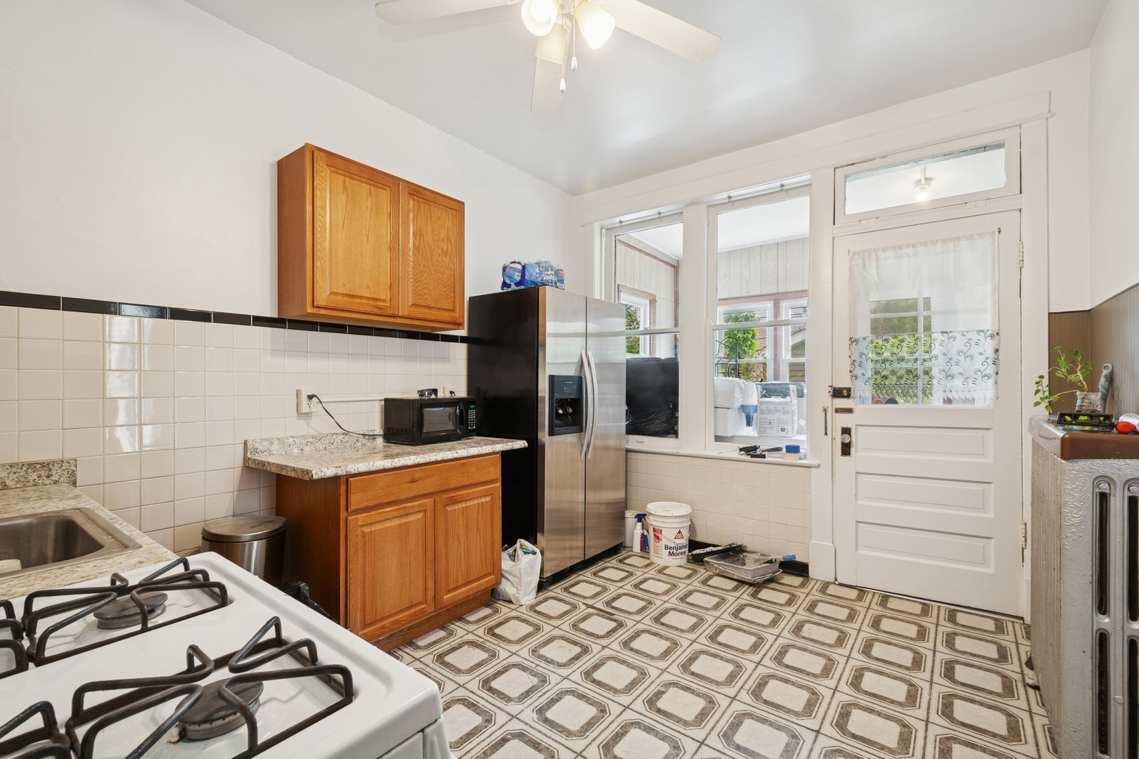 2627 West Rice Street Chicago, IL 60622 - Photo 8 of 14 a kitchen with a stove a sink and a refrigerator