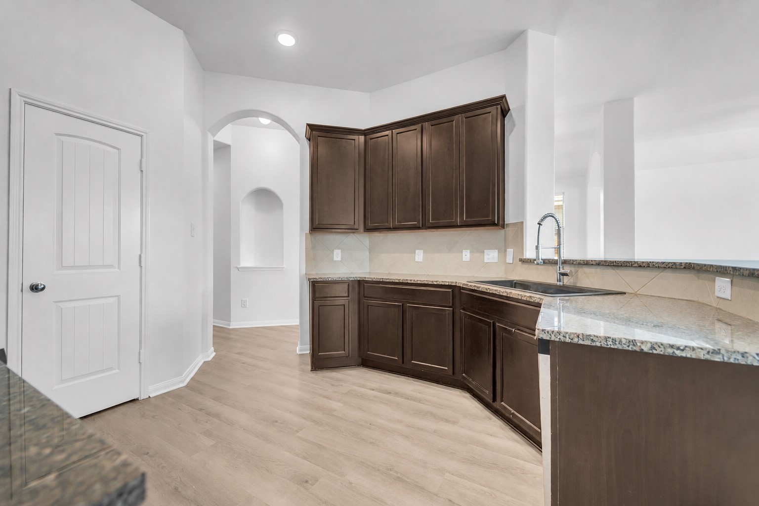 4707 Waukegan Road Conroe, TX 77306 - Photo 14 of 31 It includes a convenient pantry, providing extra storage space for ingredients, cookware, and everyday essentials while keeping the counters organized.