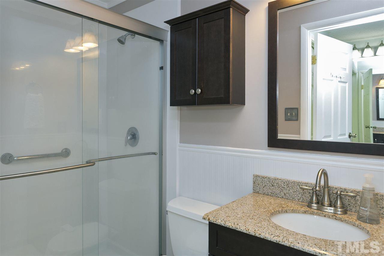 408 Electra Drive Cary, NC 27513 - Photo 13 of 25 a bathroom with a granite countertop sink and a mirror