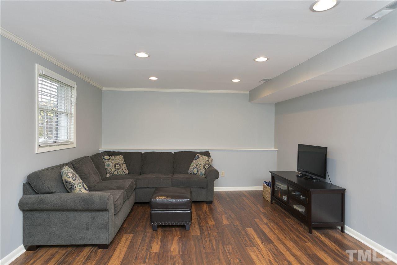 408 Electra Drive Cary, NC 27513 - Photo 17 of 25 a living room with furniture and a flat screen tv