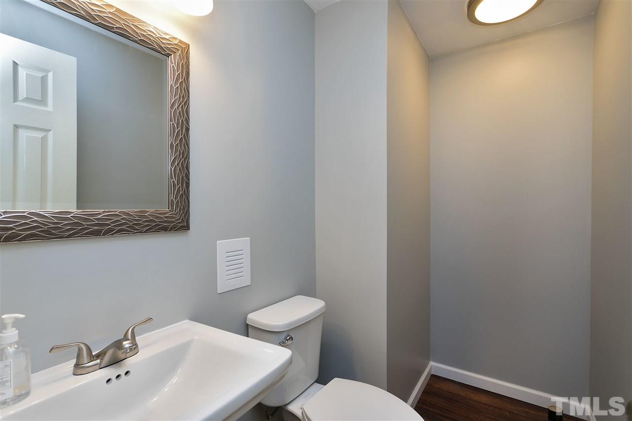 408 Electra Drive Cary, NC 27513 - Photo 20 of 25 a bathroom with a sink a toilet and mirror