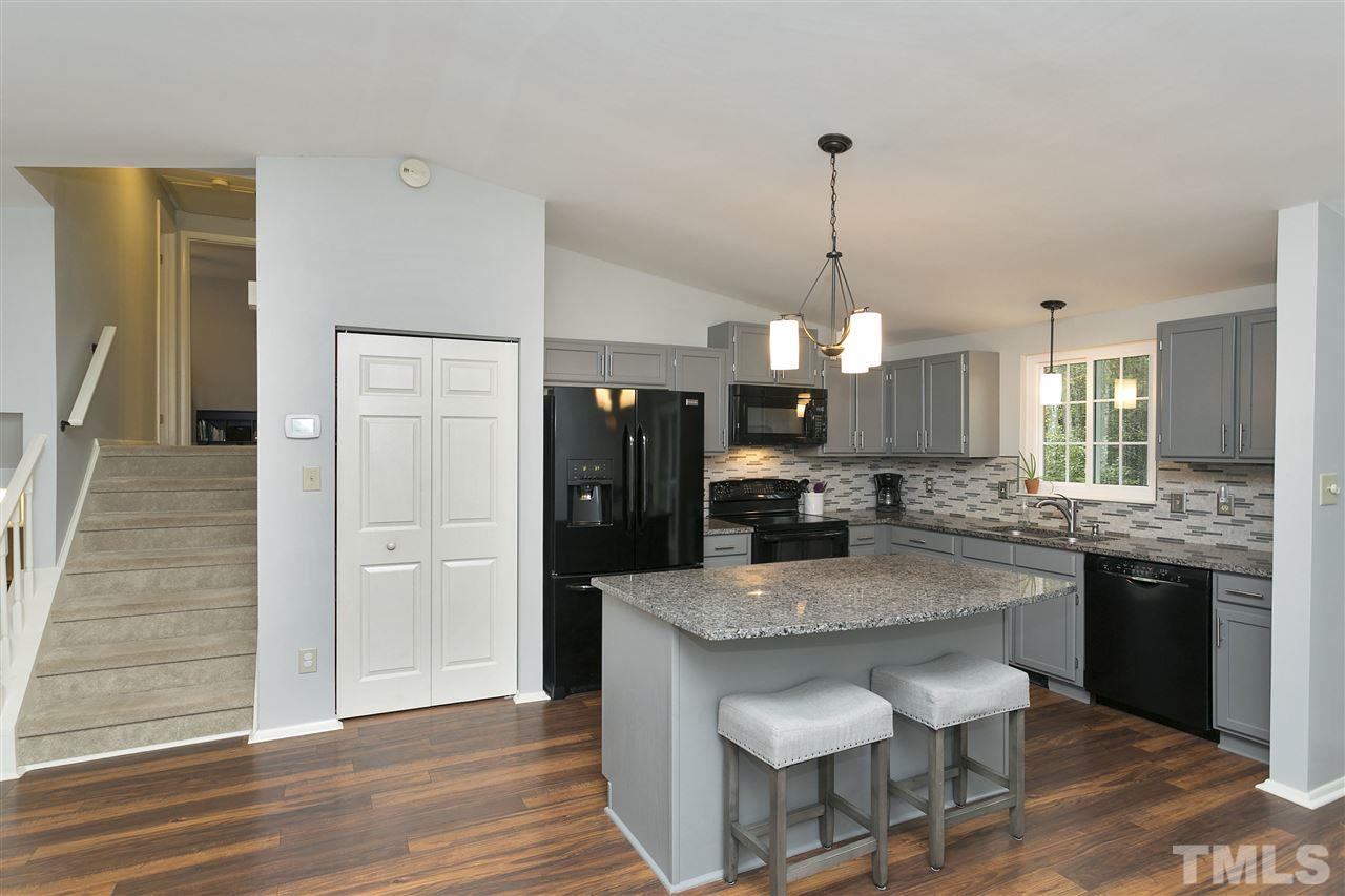 408 Electra Drive Cary, NC 27513 - Photo 5 of 25 a kitchen with granite countertop kitchen island wooden cabinets and refrigerator