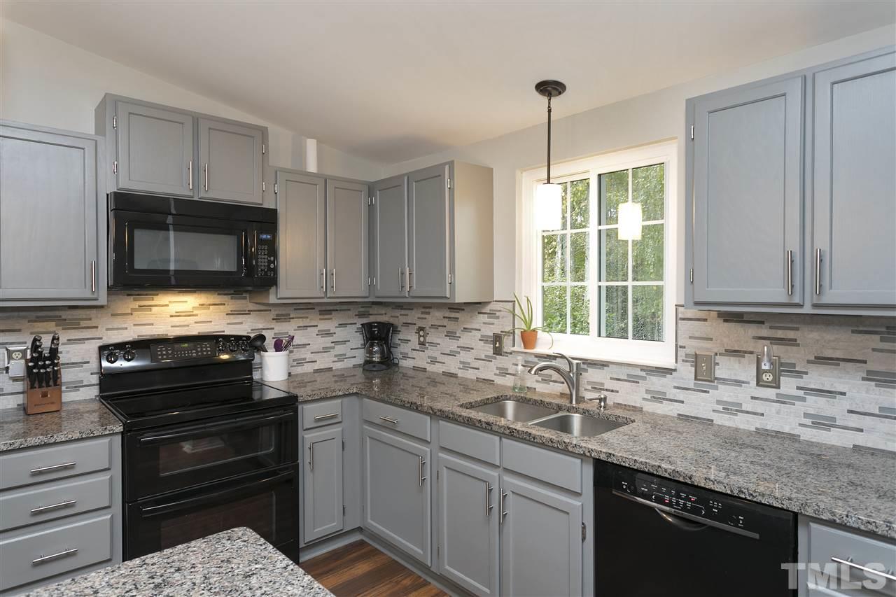 408 Electra Drive Cary, NC 27513 - Photo 8 of 25 a kitchen with a sink stove and microwave