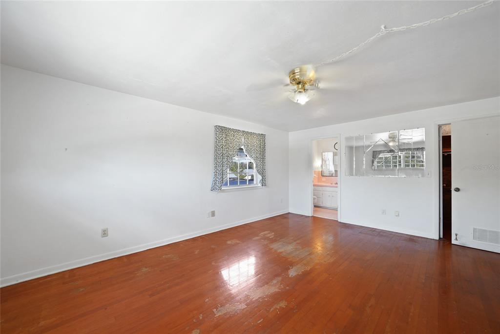 612 West Whidden Street Arcadia, FL 34266 - Photo 27 of 58 wooden floor in an empty room with a window