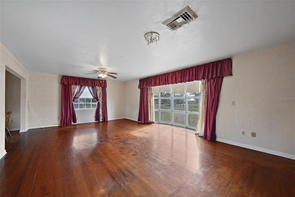 612 West Whidden Street Arcadia, FL 34266 - Photo 4 of 58 a view of an empty room with wooden floor and a window