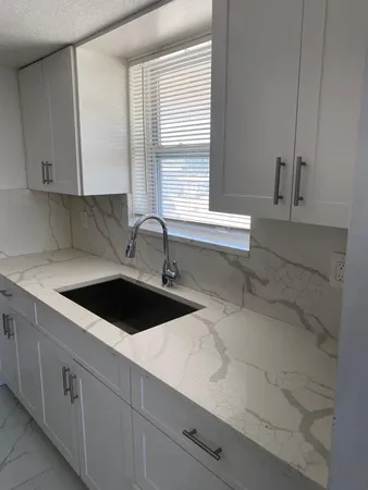a kitchen with a sink and cabinets
