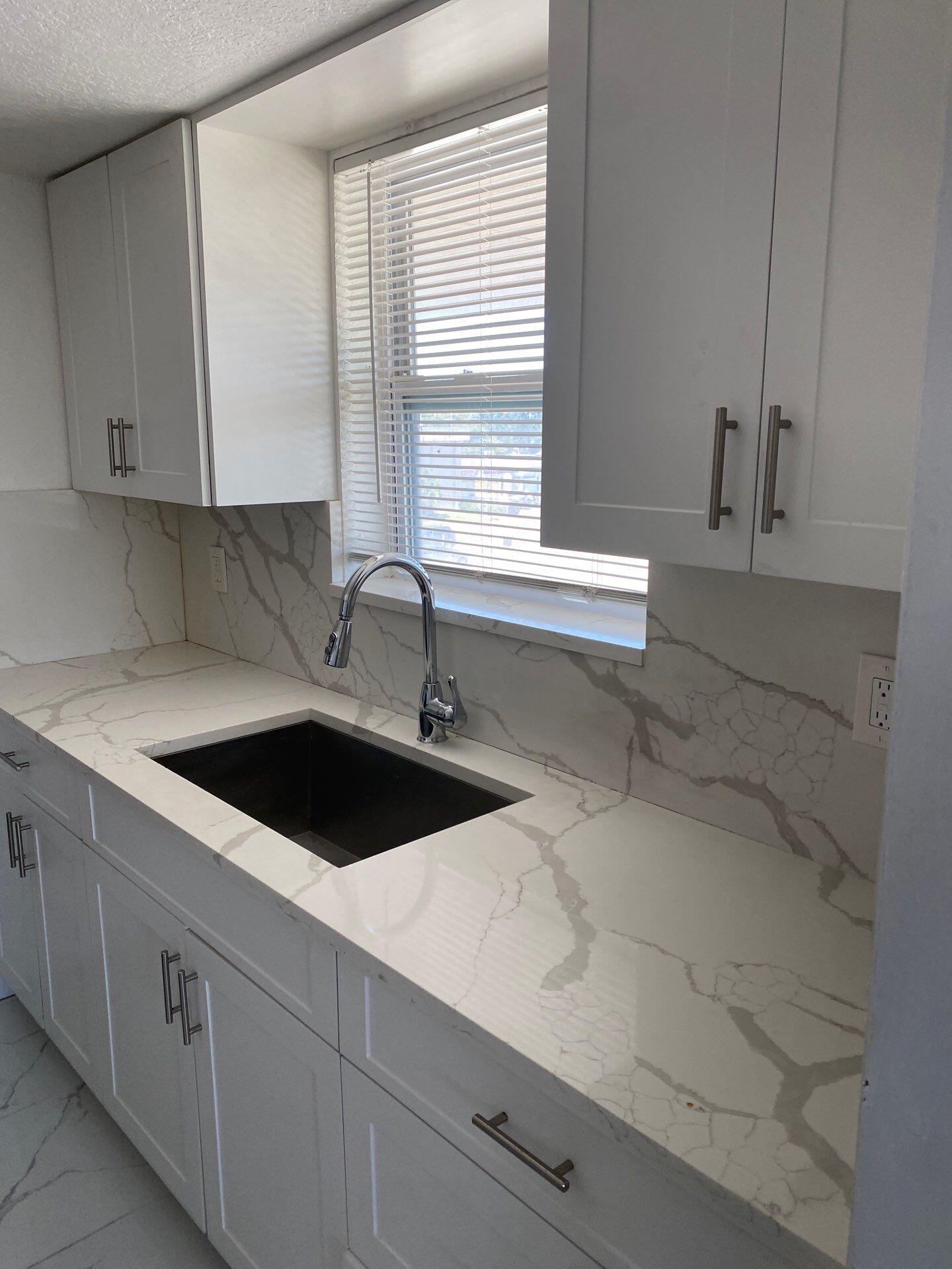 1150 East Sample Road, Unit 302 Pompano Beach, FL 33064 - Photo 1 of 3 a kitchen with a sink and cabinets