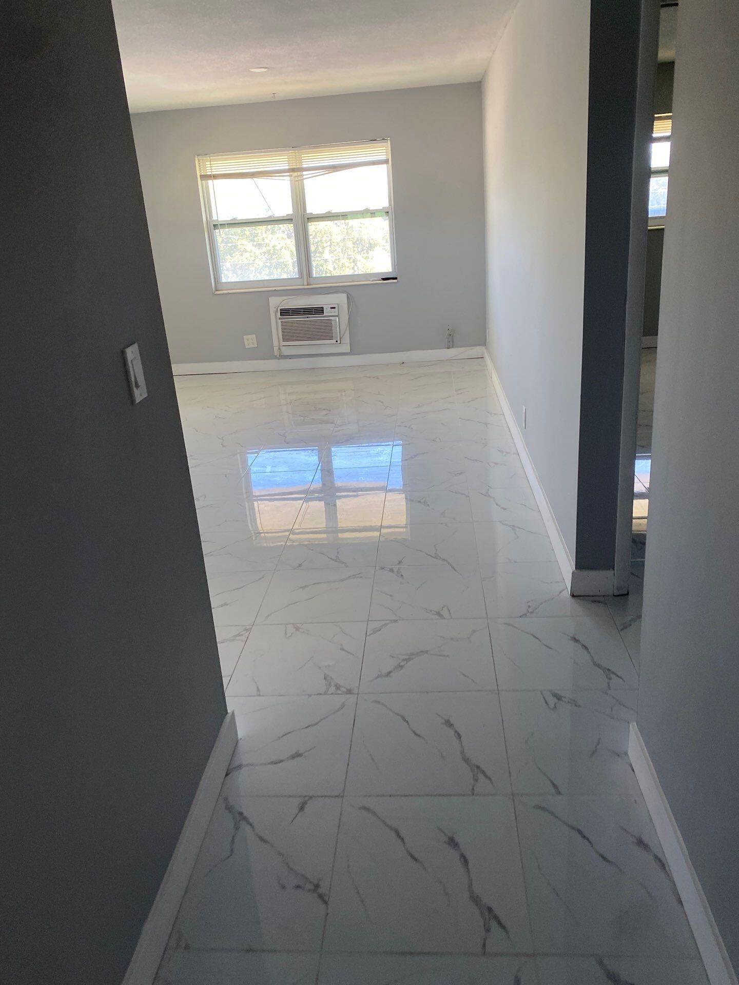 1150 East Sample Road, Unit 302 Pompano Beach, FL 33064 - Photo 2 of 3 a view of an empty room and window