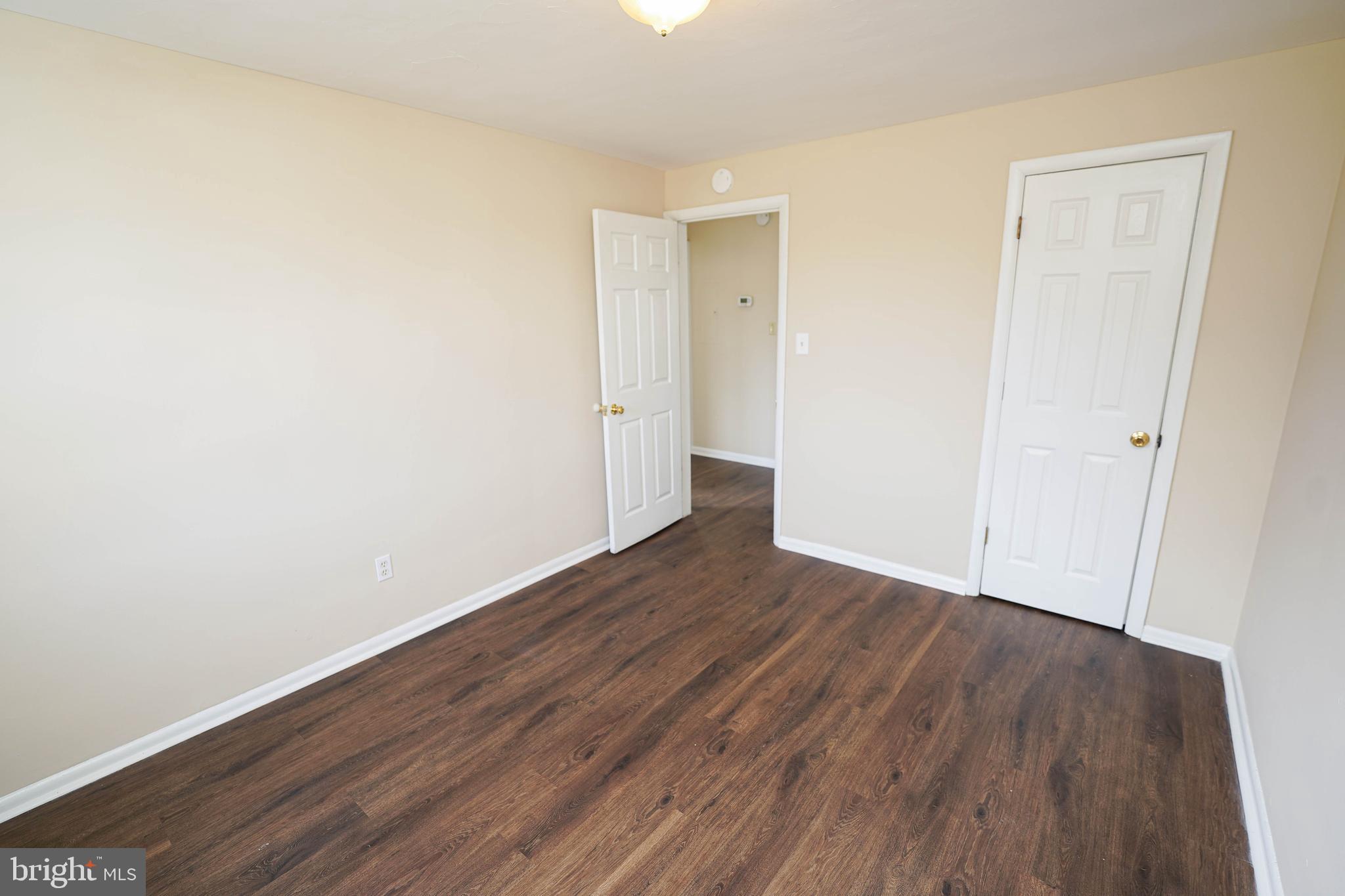 516 Bay Street, Unit D4 Berlin, MD 21811 - Photo 19 of 27 a view of an empty room with wooden floor