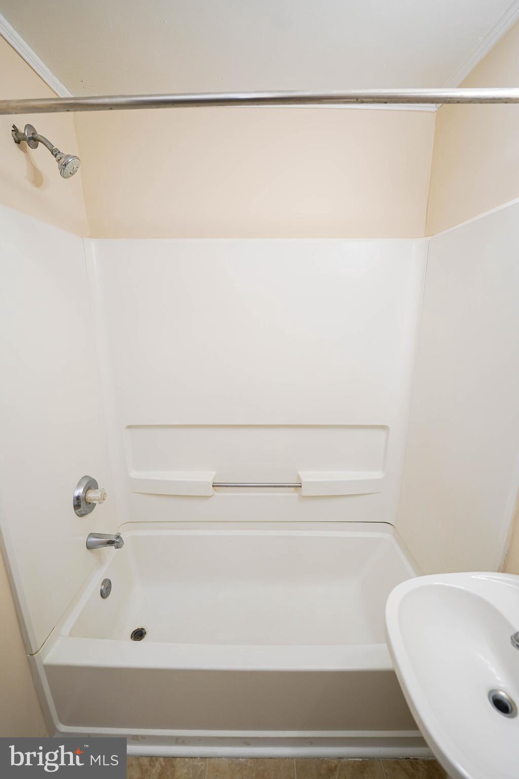 516 Bay Street, Unit D4 Berlin, MD 21811 - Photo 23 of 27 a bathroom with a bathtub and shower