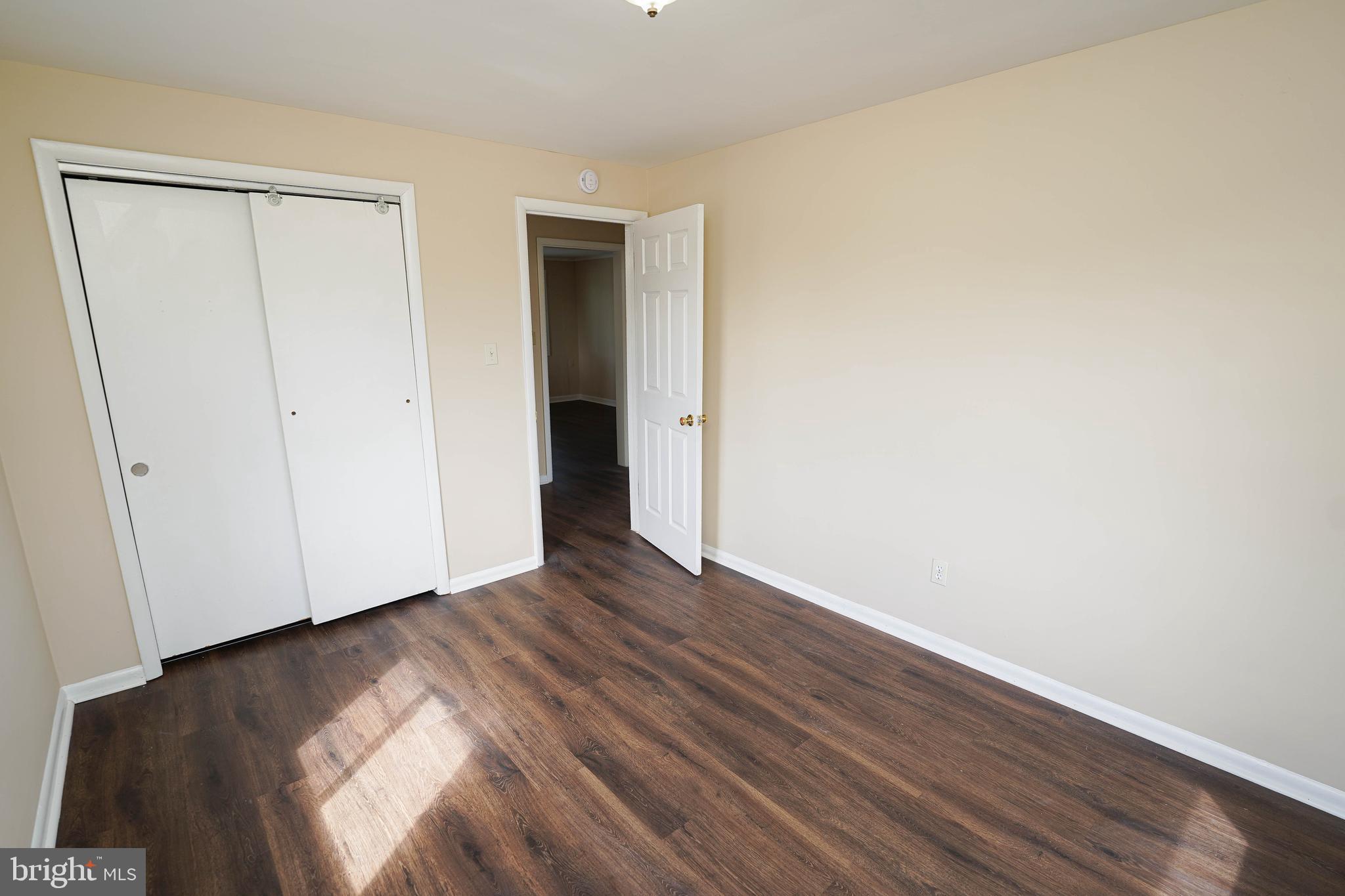 516 Bay Street, Unit D4 Berlin, MD 21811 - Photo 25 of 27 a view of an empty room with wooden floor and closet