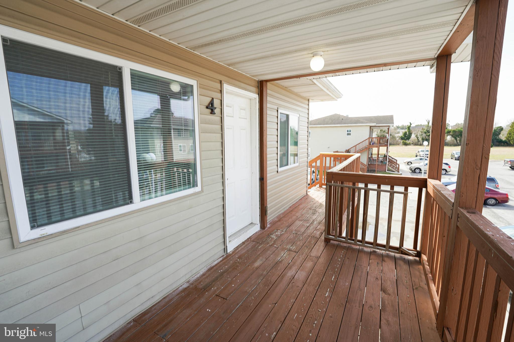516 Bay Street, Unit D4 Berlin, MD 21811 - Photo 3 of 27 a view of a balcony with wooden floor