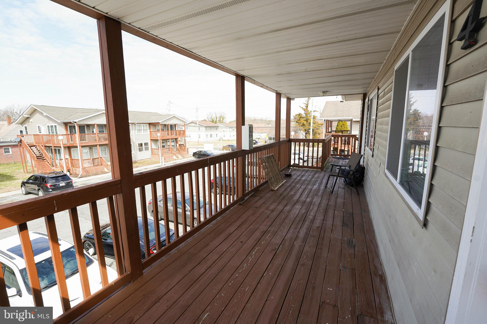 516 Bay Street, Unit D4 Berlin, MD 21811 - Photo 5 of 27 a view of a balcony with wooden floor