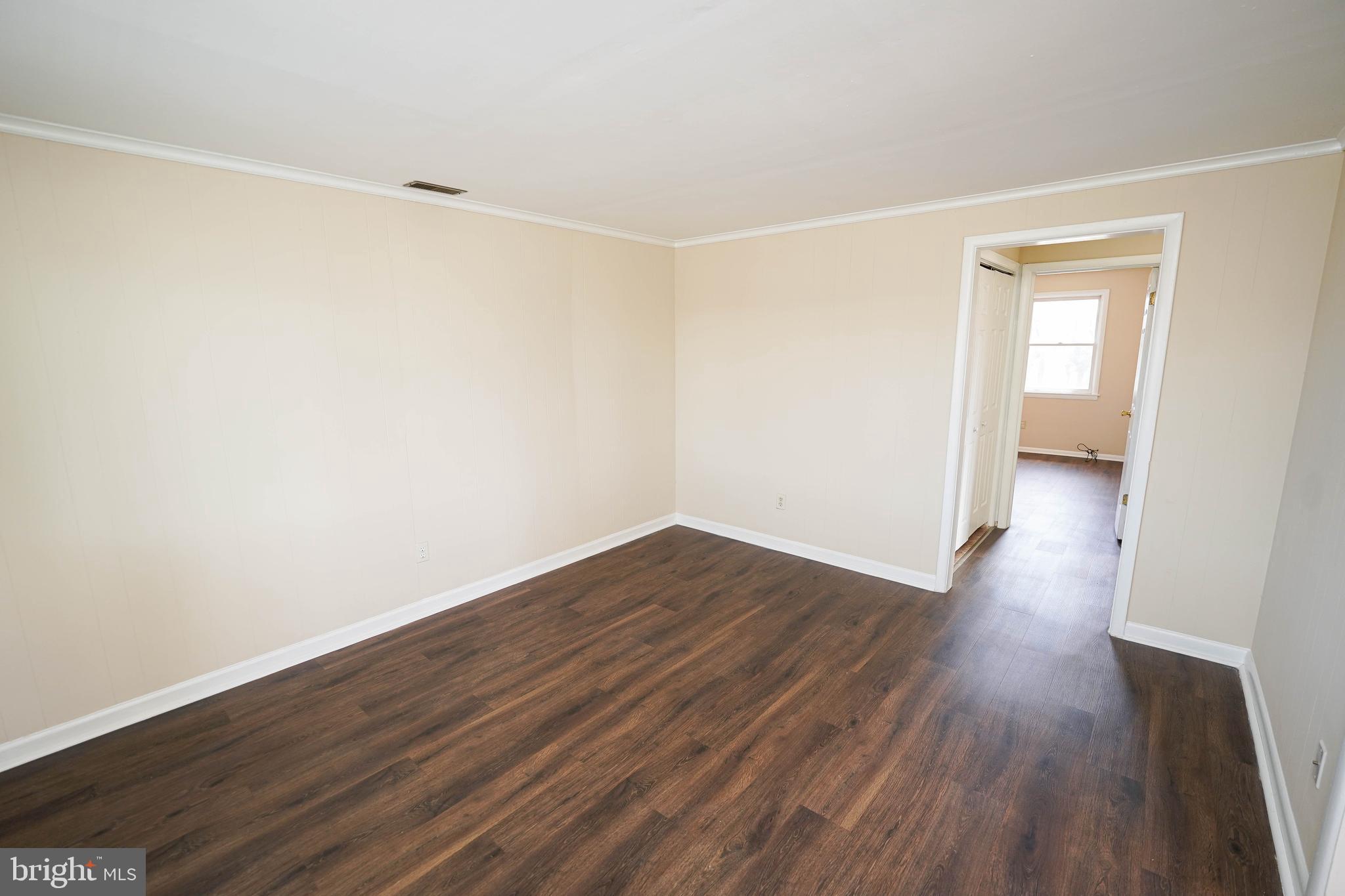 516 Bay Street, Unit D4 Berlin, MD 21811 - Photo 8 of 27 a view of an empty room with wooden floor