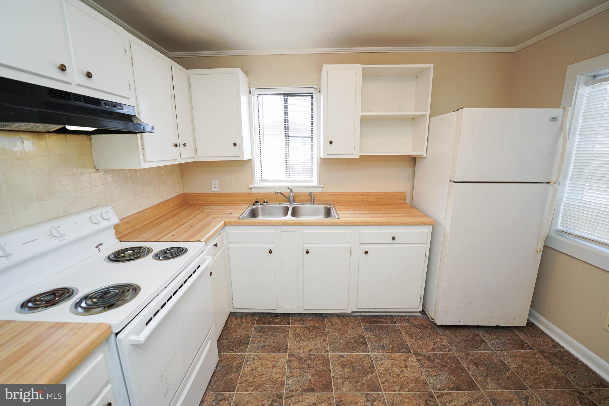516 Bay Street, Unit D4 Berlin, MD 21811 - Photo 10 of 27 a kitchen with a refrigerator sink stove and cabinets