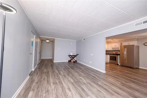 a view of a room with wooden floor and a window