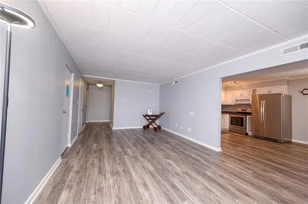 a view of a room with wooden floor and a window
