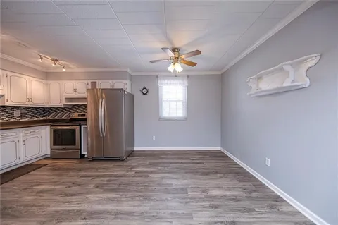 a view of kitchen with sink stainless steel appliances and window