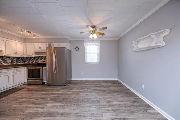 a view of kitchen with sink stainless steel appliances and window