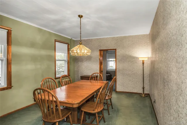 a dining room with furniture a chandelier and window