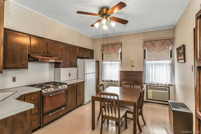 a kitchen with stainless steel appliances granite countertop a refrigerator a stove top oven a sink dishwasher and wooden cabinets