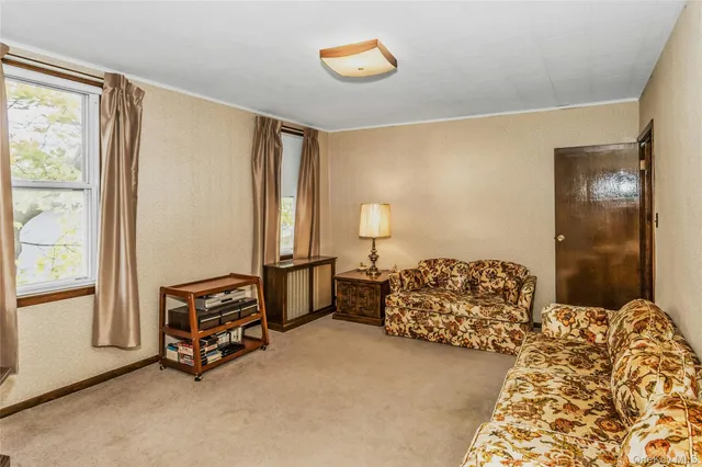 a view of room with window and furniture