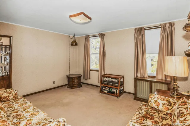 a bedroom with a bed and a dresser next to a window