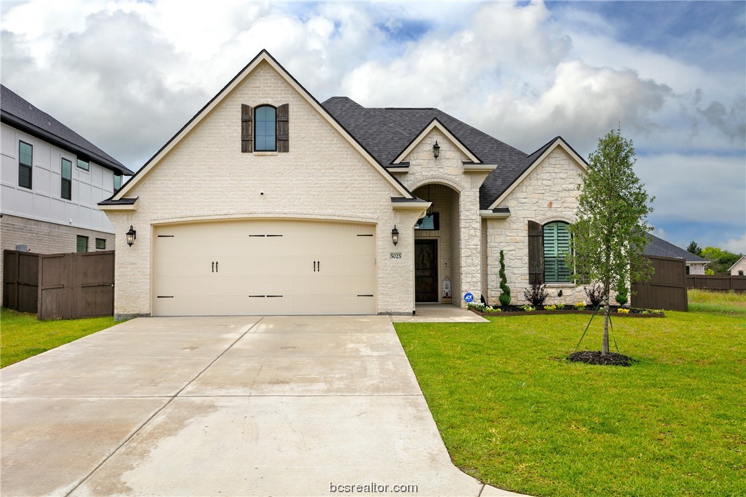 5025 Grayson Way Bryan, TX 77802 - Photo 1 of 1 a front view of a house with a yard and garage